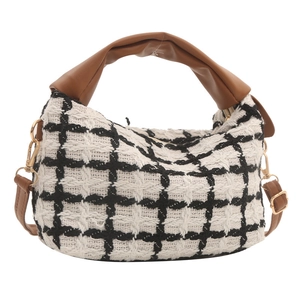 Classic black and white checkered tweed shoulder bag with brown leather handles and gold hardware