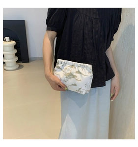 Detail of nylon pouch with landscape print and elegant pleated elastic closure