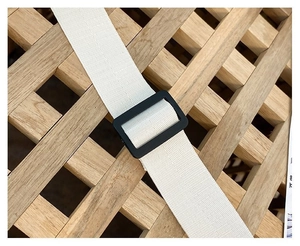Detail of white cotton woven strap with black adjustable buckle for canvas crossbody bag