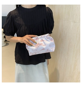 Close-up of nylon fabric bag with scenic landscape prints and elegant silver ring detail