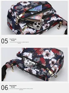 Detail showing multi-layer zipper pockets on floral nylon crossbody bag with gold hardware