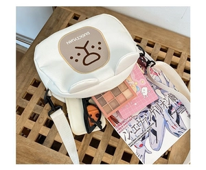 Detailed interior view of white cartoon bear crossbody bag showing space for phone and makeup