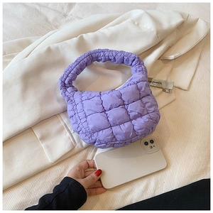 Detailed view of purple cloud handbag texture on white shirt with a smartphone