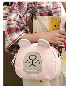 Detailed close-up of a pink bear crossbody bag with cute facial embroidery and 3D ears