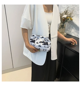 Detail of white nylon clutch with black ink landscape painting and pleated closure