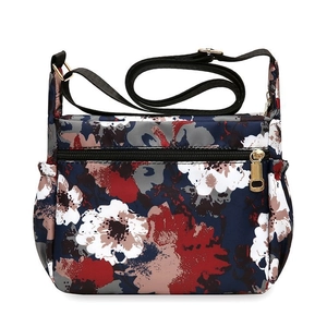 Floral print navy blue nylon crossbody bag with adjustable wide strap and gold hardware
