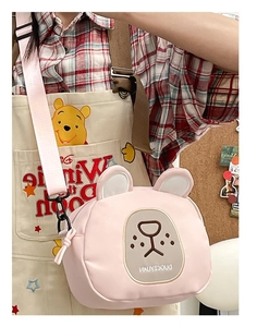 Detail view of the pink bear-shaped crossbody bag with soft texture and adjustable strap