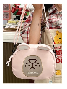 Detail of pink cartoon bear crossbody bag showing cute ears and adjustable strap