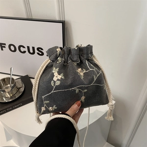 Sac seau gris foncé avec broderies florales, fermeture par cordon et bandoulière