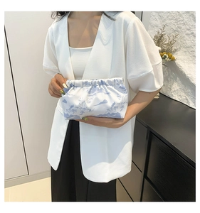 Detail of the pleated opening and blue landscape print on the nylon fabric bag