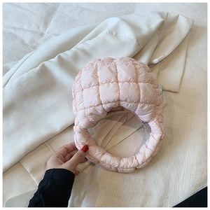 Detail shot of light pink quilted cloud bag featuring bubble texture and soft handle