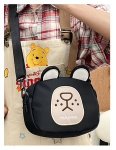 Close-up of cute black bear canvas crossbody bag with adjustable strap and ear detail