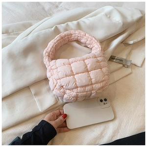 Quilted light pink puffer bag detail showing internal space for a mobile phone
