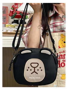 Detail view of the black bear-shaped nylon crossbody bag with cute dual-tone bear ears