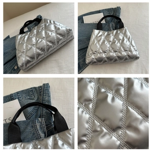 Detail of silver metallic quilted handbag with black webbing handles and macro stitch texture