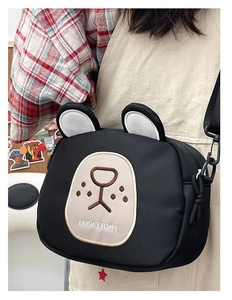 Close-up of black nylon cartoon bear crossbody bag with embroidery and 3D ears