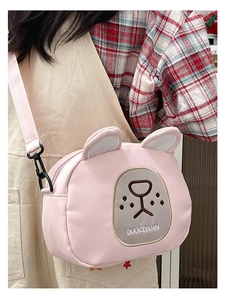 Close-up of pink rabbit cartoon crossbody bag showing embroidery and woven strap details