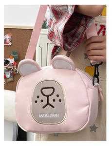 Detail of pink bear canvas crossbody bag showing embroidery and adjustable strap
