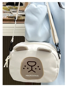 Close-up of cute white canvas bear crossbody bag for children with adjustable nylon strap