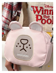 Detailed close-up of pink bear canvas crossbody bag with embroidery and adjustable strap
