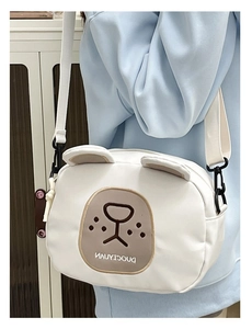 Detail of white cartoon bear crossbody bag with 3D ears and embroidered facial features