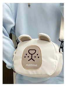 Detail of cute white cartoon bear crossbody bag with embroidery and adjustable strap