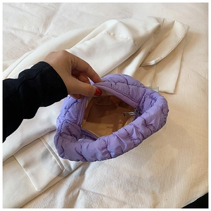Close-up of purple quilted cloud bag showing inner lining and zipper closure space