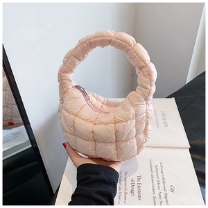 Detail showing soft light pink quilted cloud bag with silver zipper and puffy texture