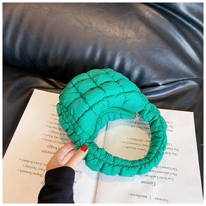Macro shot of green pleated cloud bag texture with high-quality nylon diamond quilting