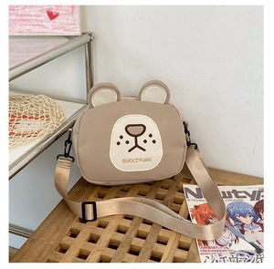 Detail of cute bear canvas crossbody bag showing texture and adjustable nylon strap