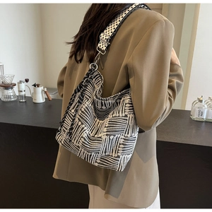 Detail of black and white striped canvas bag with textured jacquard and wide strap