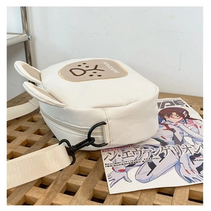 Detail of white canvas crossbody bag with cute rabbit ears and adjustable wide strap