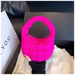 Close-up of vibrant magenta quilted cloud bag with premium nylon texture and metal zipper