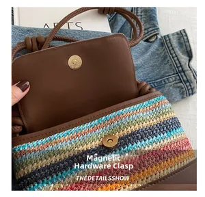 Detail showing golden magnetic buckle closure on a woven crossbody bag with striped pattern