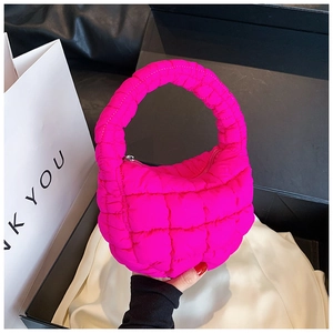 Detail view of the rose pink quilted cloud bag featuring a glossy puffer finish and zipper