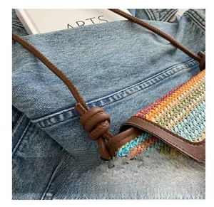 Detail of colorful striped woven straw bag with premium brown leather straps and knots
