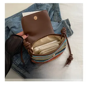 Interior view of colorful woven bag showing capacity for smartphone and zipper wallet
