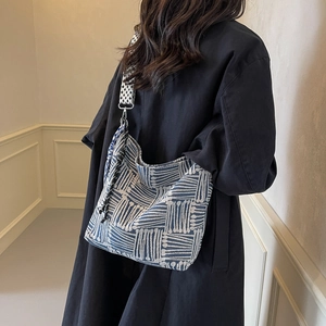 Large blue and beige woven striped canvas hobo bag with checkered wide shoulder strap