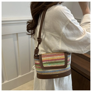 Close-up of colorful woven texture and brown leather trim with knotted strap detail