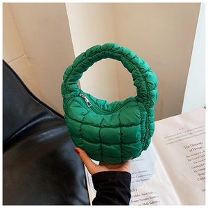 Macro detail of the bright green quilted bubble handbag featuring chic ruched handle design