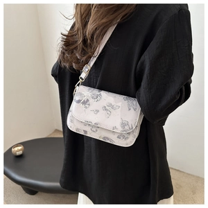 Detail of grey butterfly print on minimalist small square flap bag with gold buckles