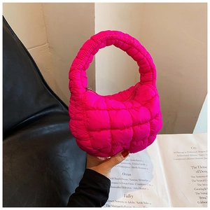 Detail of hot pink quilted cloud bag with padded texture and secure zipper closure