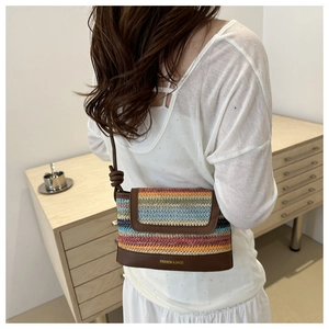 Rainbow striped woven crossbody bag with brown leather trim shown on model