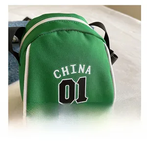 Detailed macro view of green nylon canvas crossbody bag with white China 01 lettering logo