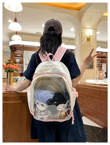 Pink and white student backpack with a clear PVC display window for plush dolls
