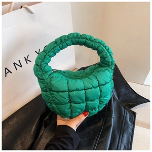 Detail of green quilted cloud bag in nylon fabric with ruched texture and top handle