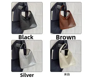 Detailed view showing four colors of high-capacity faux leather patchwork tote bags