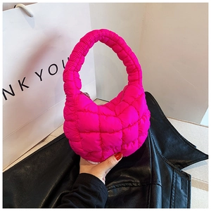 Detail of rose red quilted puffer bag showing the soft texture and stitch pattern