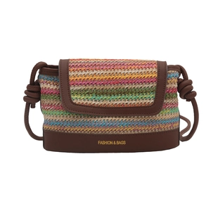 Colorful woven straw crossbody bag with brown leather trim and golden fashion lettering