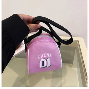 Close-up of pink canvas mini crossbody bag with China 01 lettering and black strap